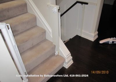 Retractable baby gates installed on both sides of stairs.