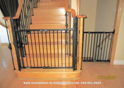 Typical black gates installed at bottom of stairs and across down stairs opening.
