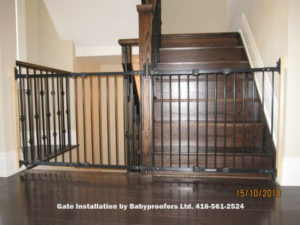 Two large black baby gates across stair openings.