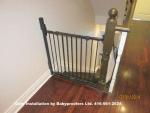 Typical simple baby gate installed between wall and newel post.