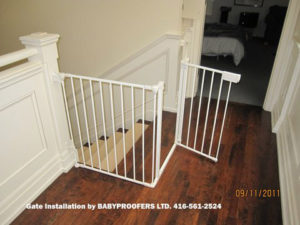 White baby gate installer with full railing on the side.