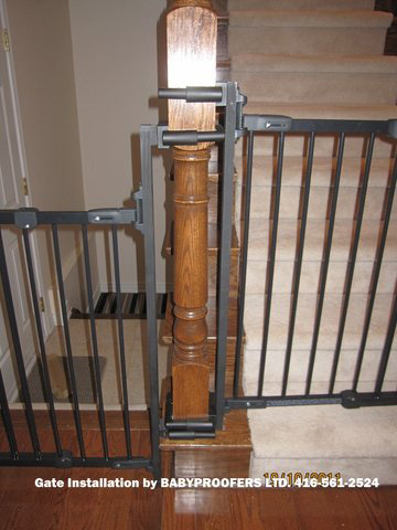 Details of mounting brackets for baby gate attached to newel post.