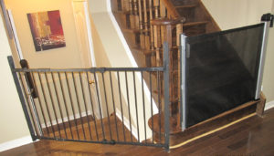 Black combination baby gate with slider on the right and swing gate on the left.