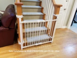 Baby gate installed to newel post without drilling holes.